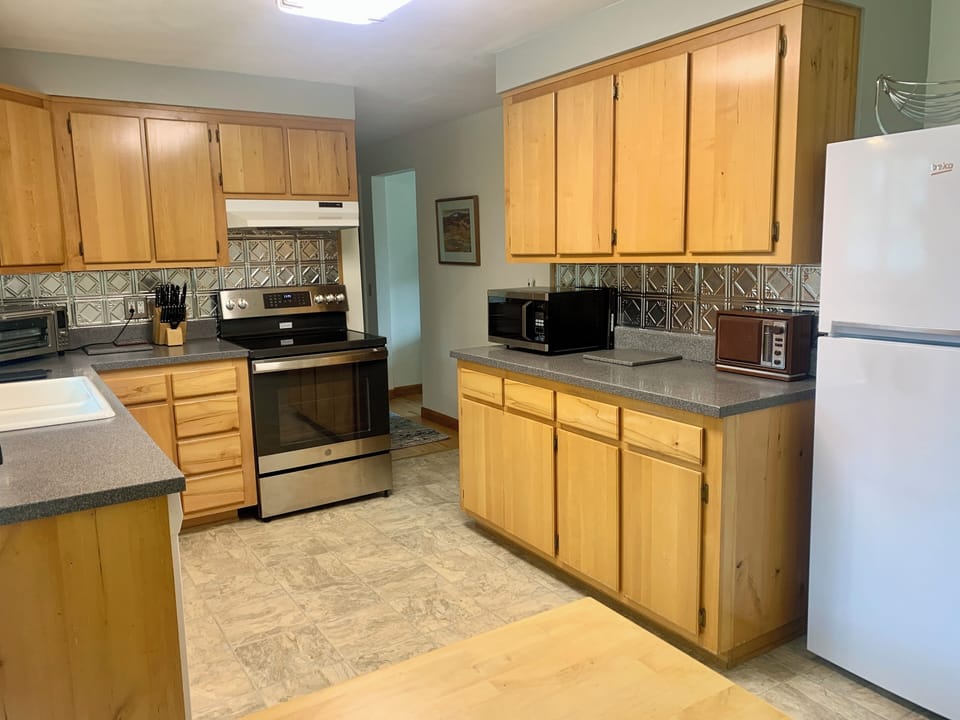 Glass top range, Beko fridge,a microwave, -- and an antique stereo AM/FM radio!