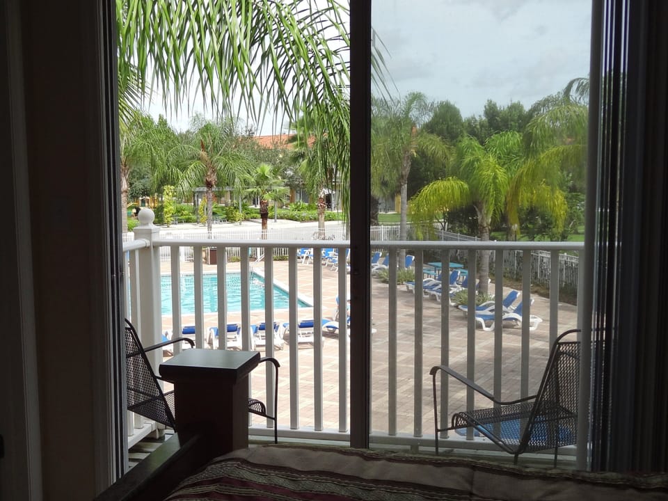 Photo taken from inside the master Bedroom, showing Balcony and pool area
