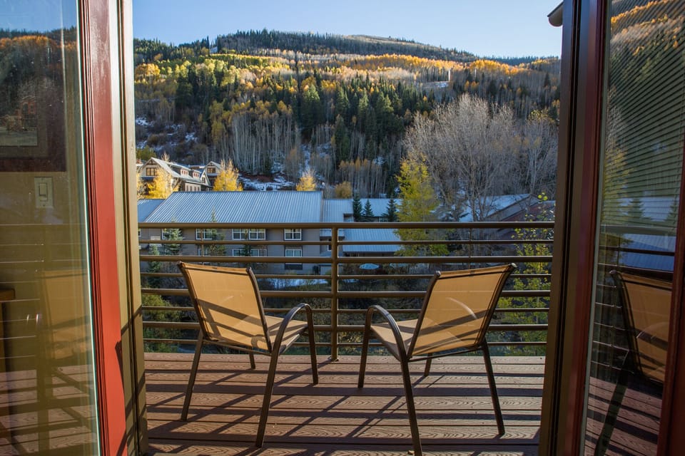 Balcony overlooking river, ski area, and mountains