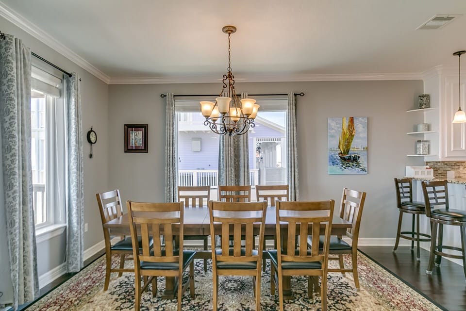 Dining table seats 8, Bar seats 3, Outside deck table seats 8.