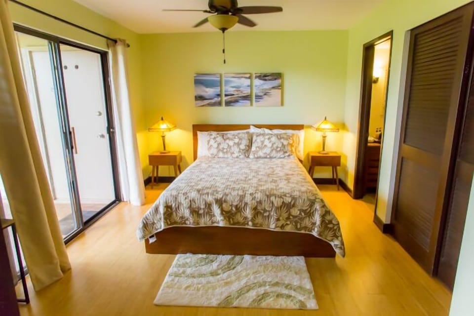 Master bedroom with garden view and private stone shower