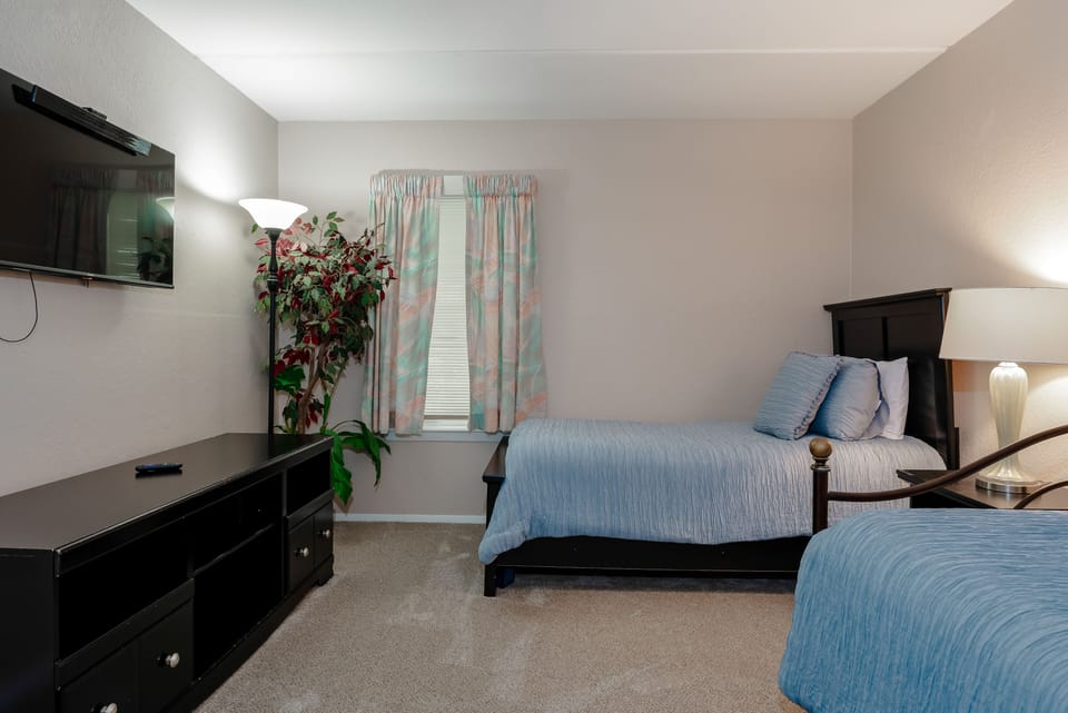Our 2nd guest room has closet and dresser space to keep your spaces tidy and a flat screen TV for the perfect movie night.