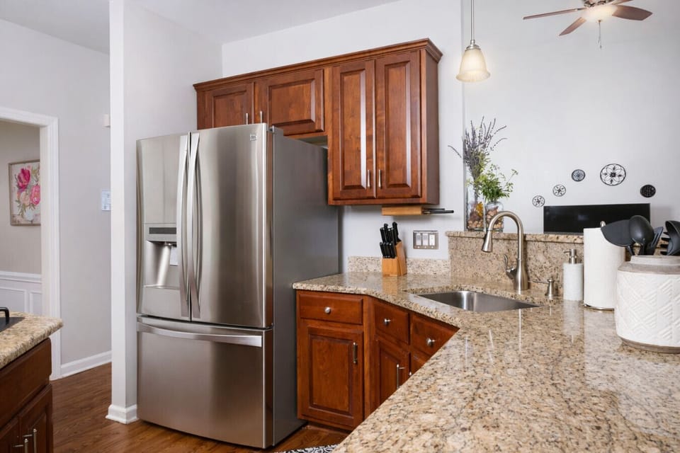 Stainless Steel Appliances and Fully Outfitted Kitchen for Cooking Meals at Home.