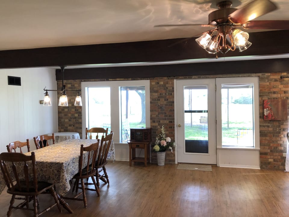 Dining area and back yard w/covered patio, seating area, fire pit, bench swing 
