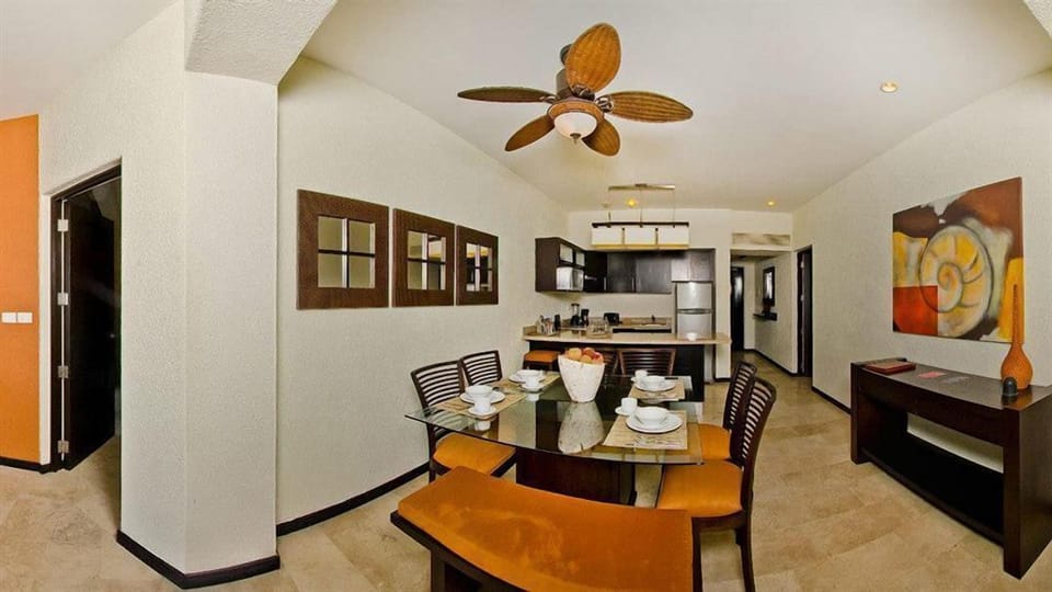 kitchen and dining area opens up to living room with large ocean view balcony
