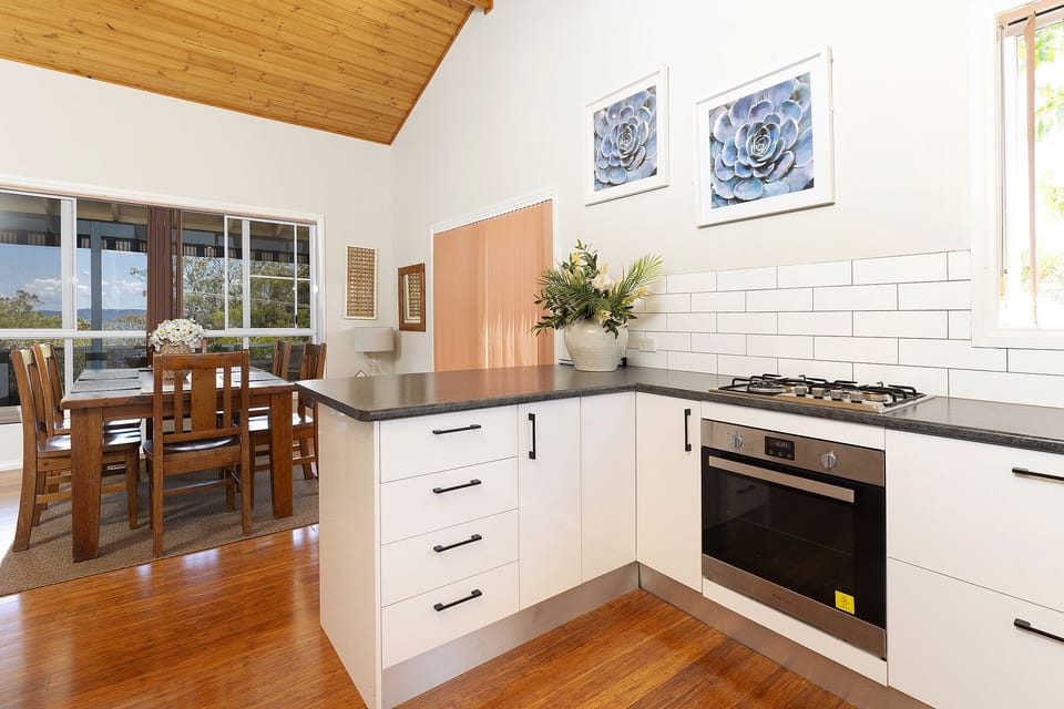 A modern and well equipped kitchen with a gas stove and electric oven