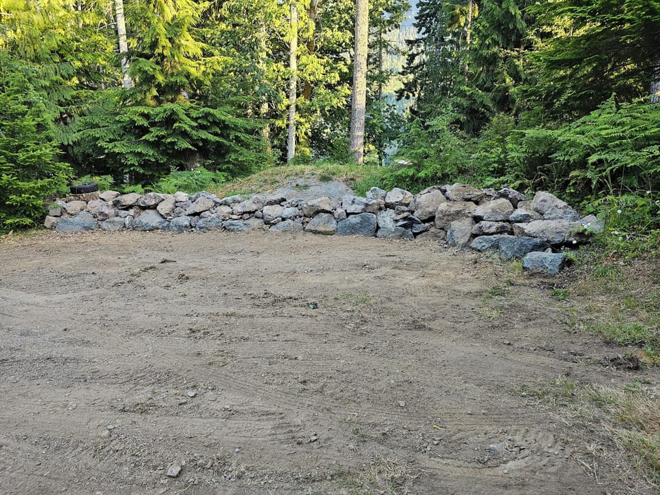 Parking area above property and before gate.