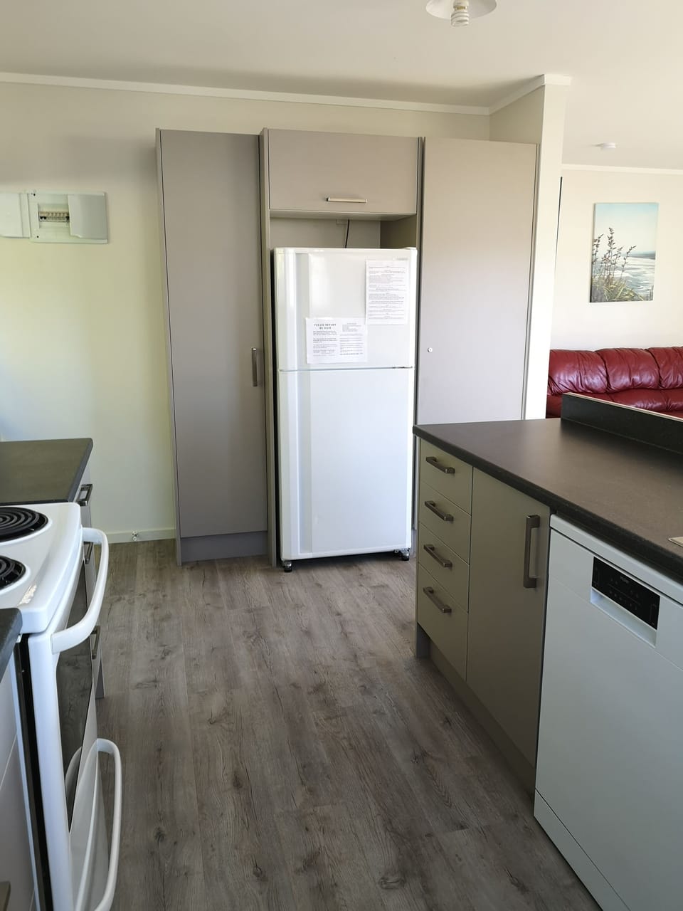Kitchen with full size fridge/freezer and dishwasher.