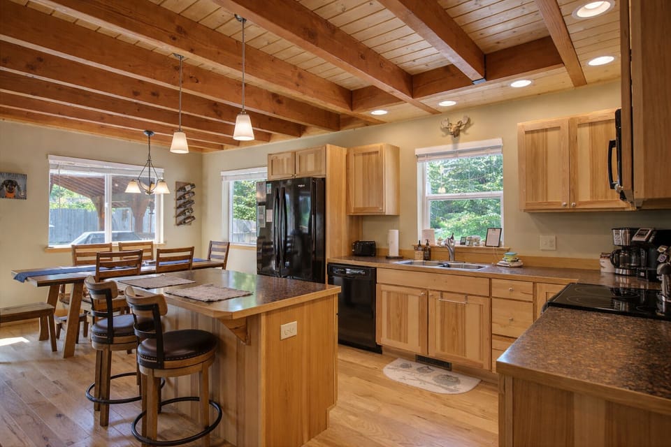 Gather around this spacious kitchen island where warm wood meets modern convenience, perfect for morning coffee or evening meal prep together.