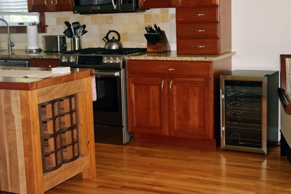 Custom wine rack and beverage fridge conveniently located by slider to pool deck
