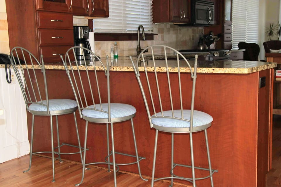 Fabulous, well stocked  kitchen with new gas range and  3 stools at the counter.