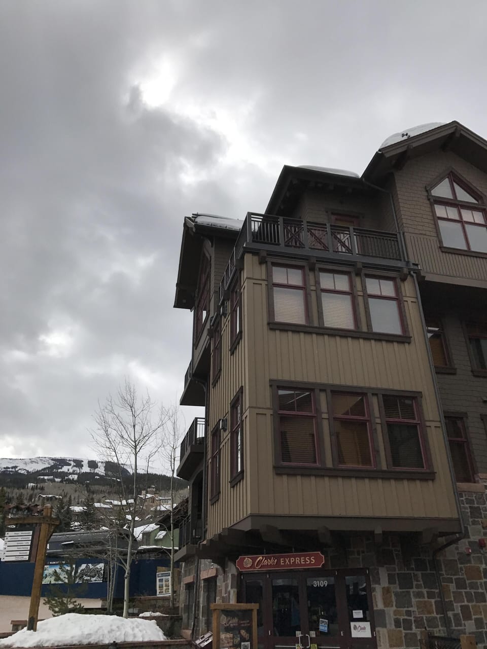 Shows upper penthouse corner unit with two balconies and high ceilings