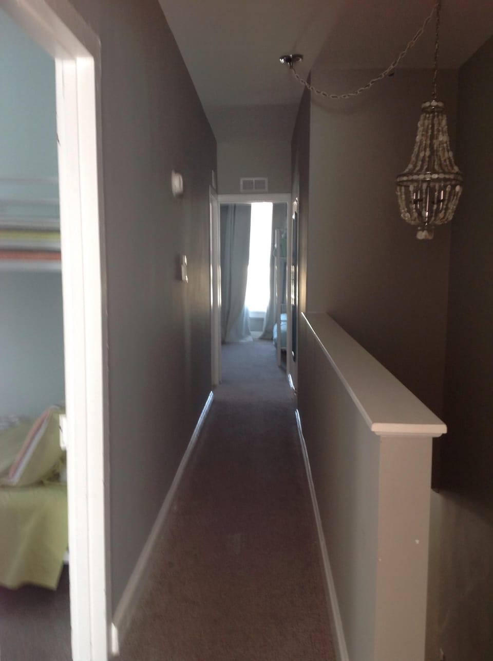 Top of staircase looking down hallway to front bedroom