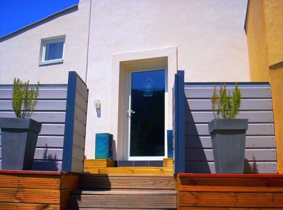 The entrance in the small east terrace