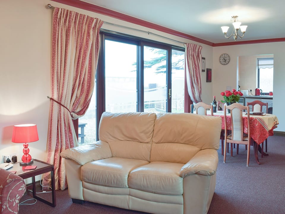 Comfortable sofa and patio doors to the garden | Elm View - Elm Cottages, Cwmbach, near Whitland