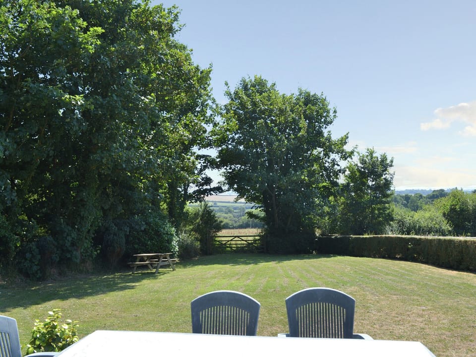 Lawned garden and wonderful views beyond | Coachmans Retreat, Pennytinney, St Kew