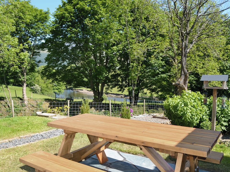Beautiful garden overlooking the River Derwent | Howe Bridge House, Portinscale, near Keswick