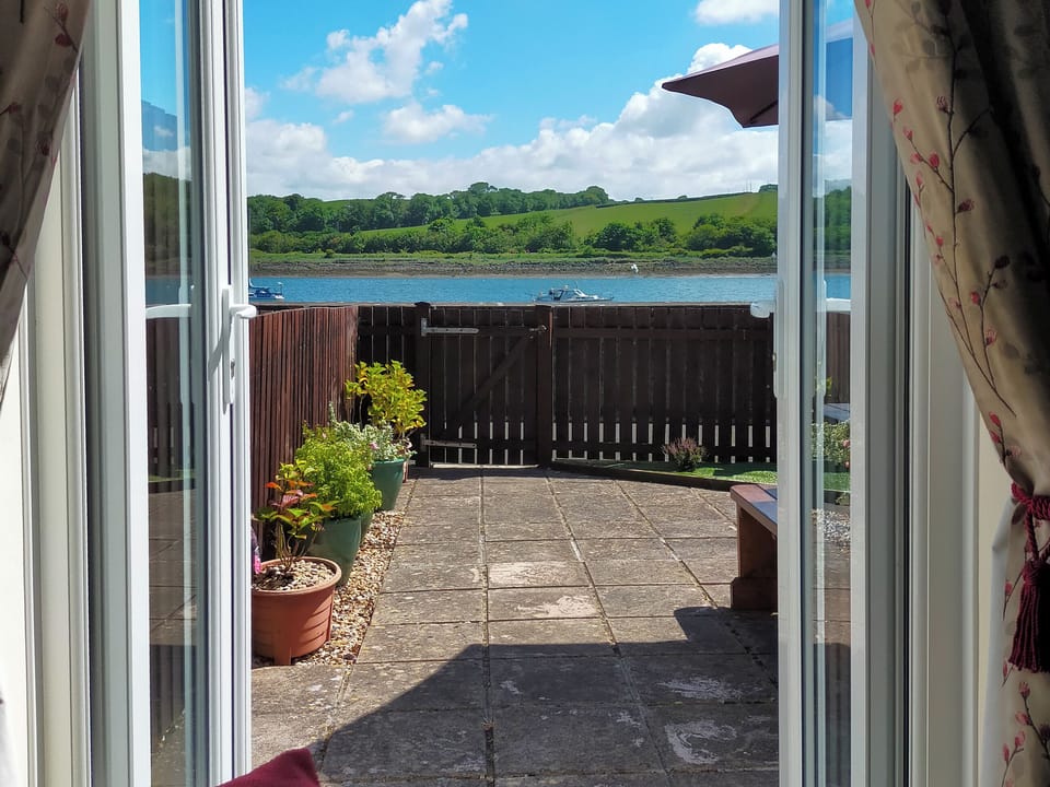 View through patio doors to river | Riverside Mews, Bideford