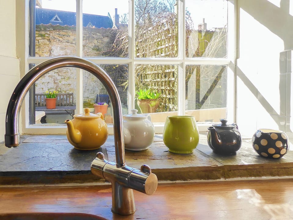 Delightful sunny traditional kitchen overlooking the courtyard garden | Forge View Cottage, Thornton-le-Dale, near Pickering