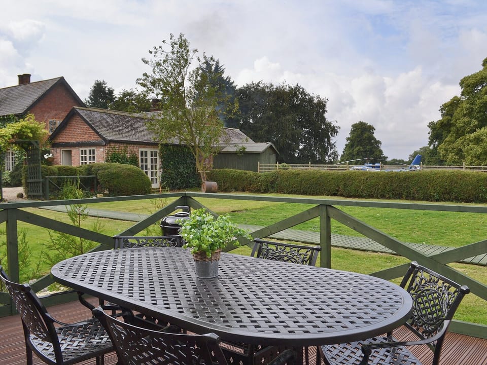 Large lawned garden with decking, patio and garden furniture | Pampita Lodge - Tickton Hall Cottages, Beverley
