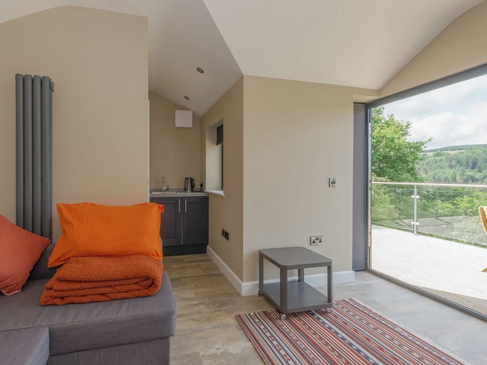 Summerhouse with kitchenette, double sofa bed, bi-folding doors leading to decking | Ivy Cottage, Beck Hole, near Whitby