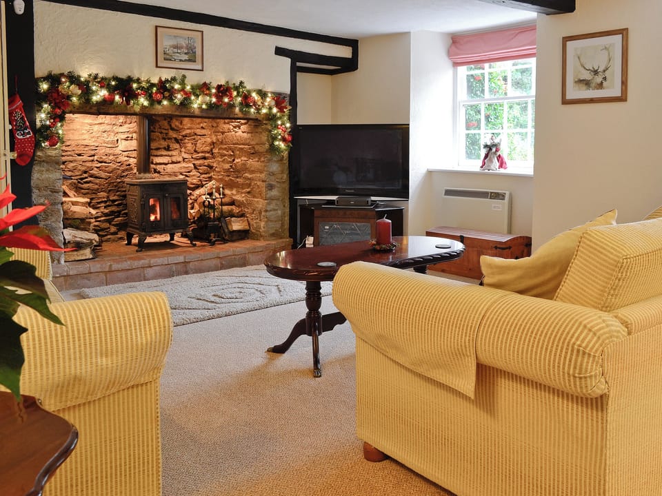 Living room with inglenook fireplace and wood burning stove | Karslake House, Winsford, near Dulverton