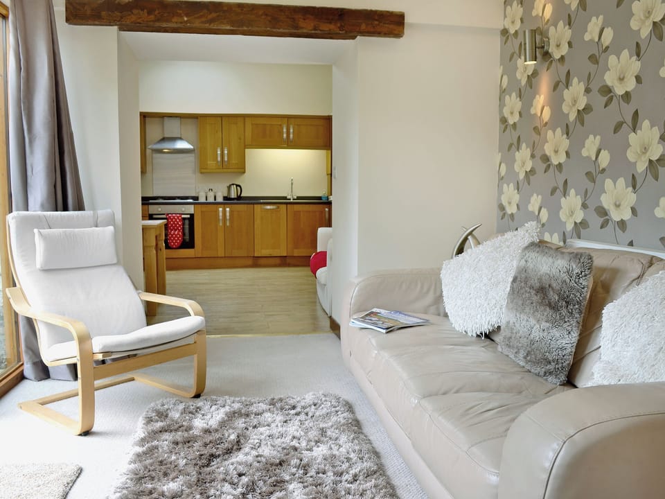 Homely living room with French doors to patio | Blackthorn Cottage, Swan Pool, near Falmouth