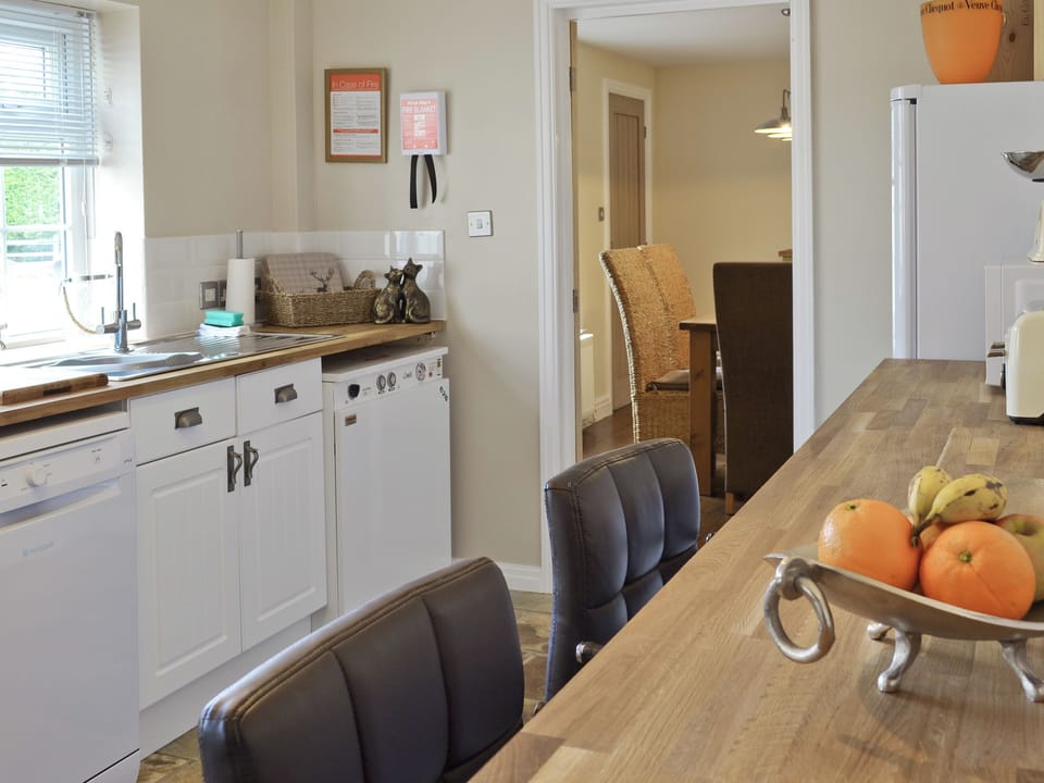 Kitchen is conveniently placed near to the dining area | Willow Tree Cottage at Cottage Farm - Cottage Farm, Foxholes, near Scarborough