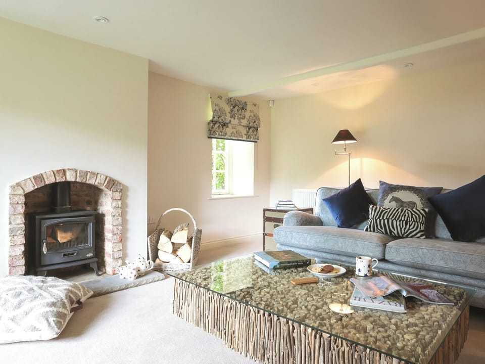 Cosy living room with wood burner | Garden Cottage, Settrington, near Malton