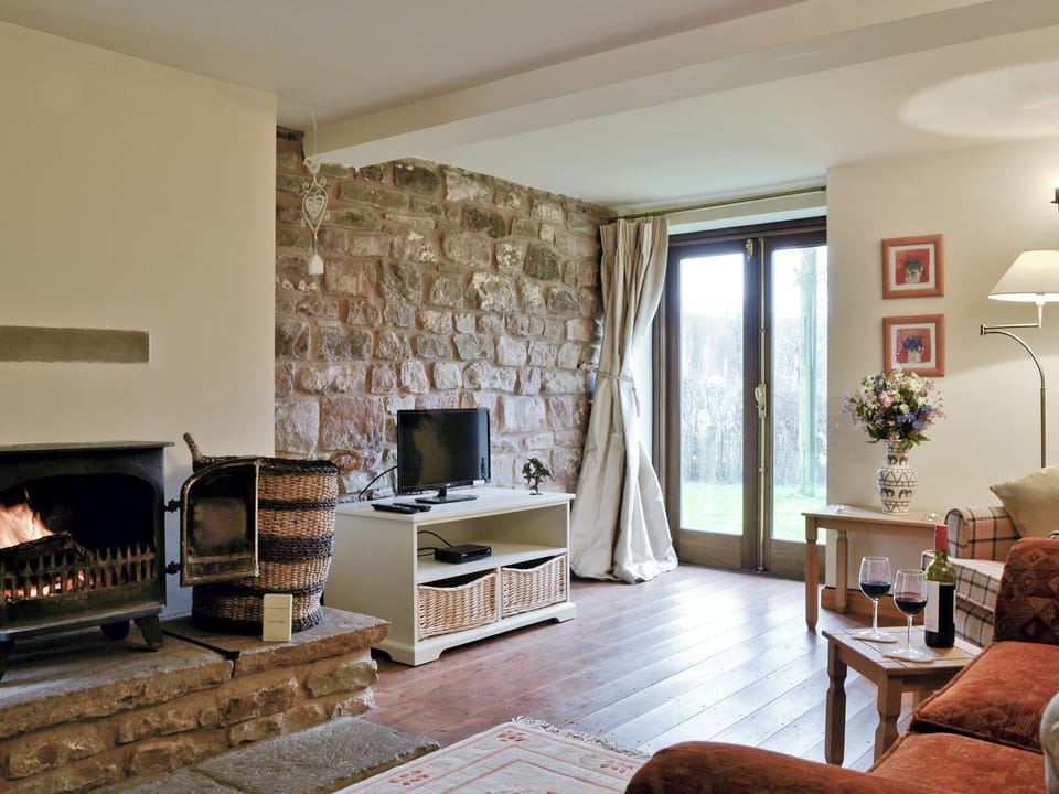 Cosy lounge with wood-burner and patio doors | Bramble Cottage - Bramble Cottage and Honey Cottage, Newland, near Coleford
