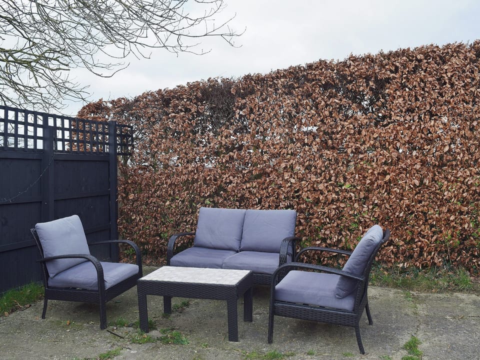 The additional seating on the patio makes an ideal space to relax with a good book | Blueberry Cottage, Debenham, near Framlingham