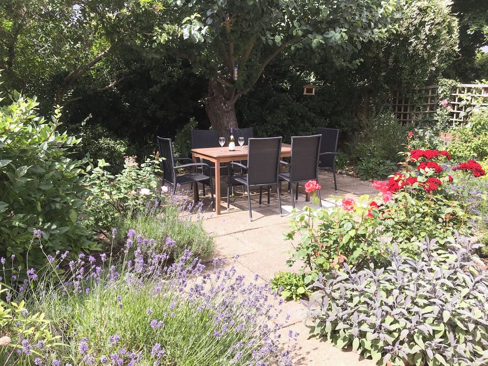 Enclosed paved garden with sitting-out area and furniture | Red Lion Corner, Lavenham