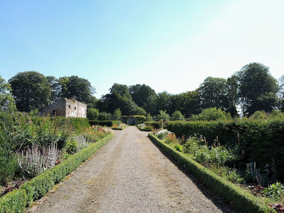 Beautiful gravelled pathways amongst delightfully planted borders | The Old Gasworks Building - Old Montrose, Montrose