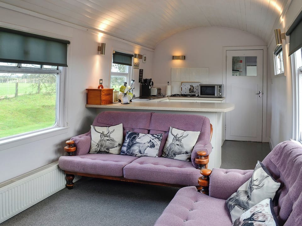 Living area with comfortable and cosy seats | The Carriage, Bridge of Dee, near Castle Douglas