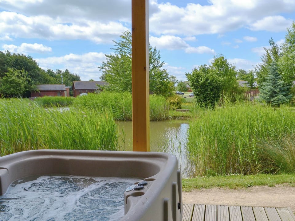 Relaxing hot tub with lovely views | Campbell Lodge, Thorpe on the Hill, near Lincoln