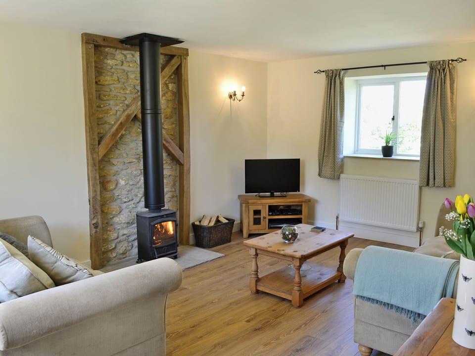 Tastefully furnished living room with cosy wood burner | Acorn Cottage - Wood Dairy, North Perrott, near Crewkerne