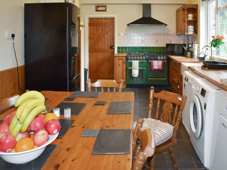 Convenient dining area within well-equipped kitchen | Oakdene Lodge, Wimborne