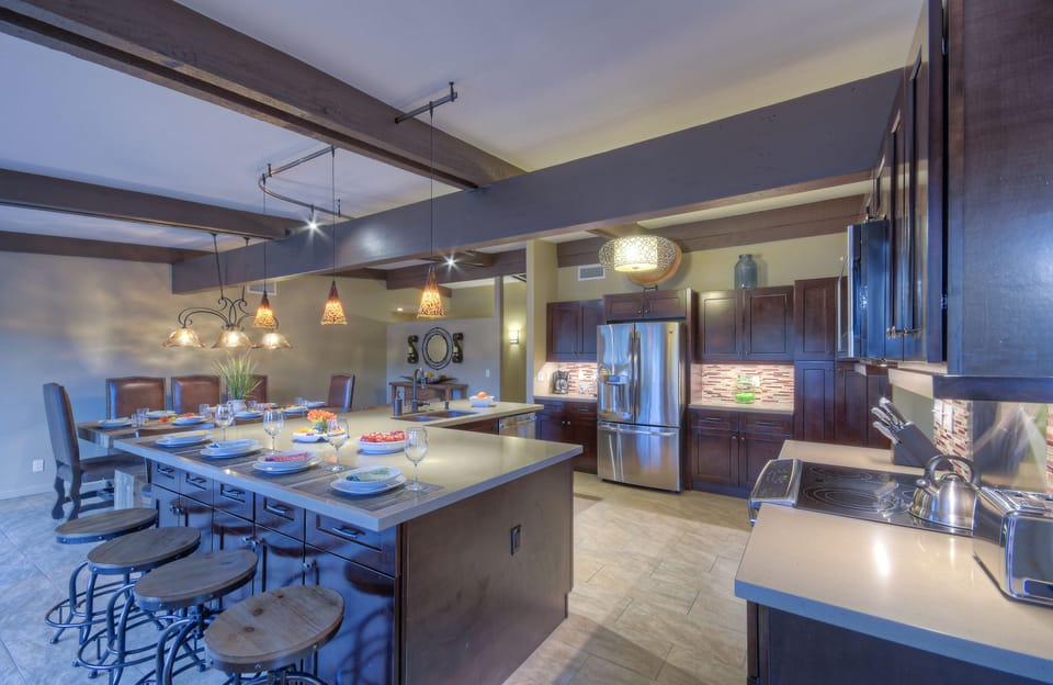 Exquisite designer kitchen with large island is well stocked with everything you need for preparing your favorite food.