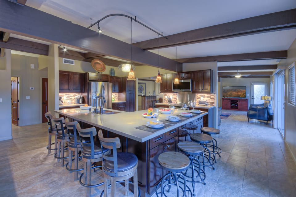Lots of seating to enjoy the exciting outdoor views at expansive kitchen island.