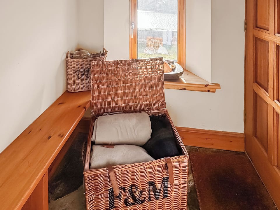 Rear lobby stocked with cozy outdoor blankets and a croquet set | Rubha Lodge, Shieldaig