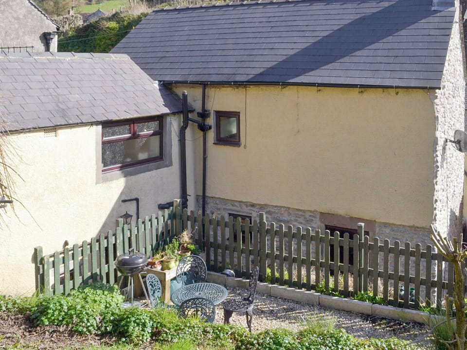 Rear of property with gravelled patio | Poppy Cottage, Bonsall, near Matlock
