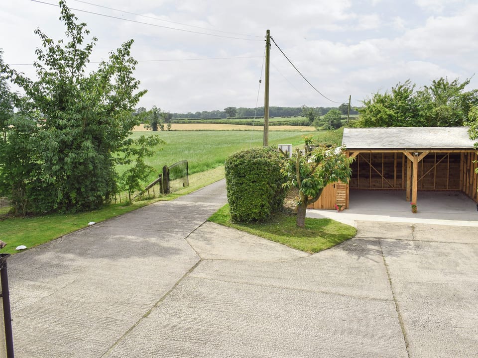 View from first floor over the parking areas and beyond | Glebe Farm Cottage, Hornby