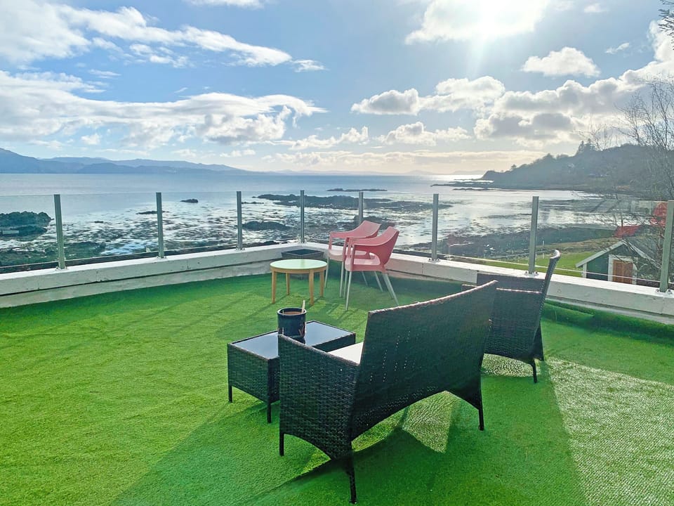 The roof terrace with door to otter bar and a walkway up from the garden | South Bay Cottage, Saasaig, Teangue, Isle of Skye