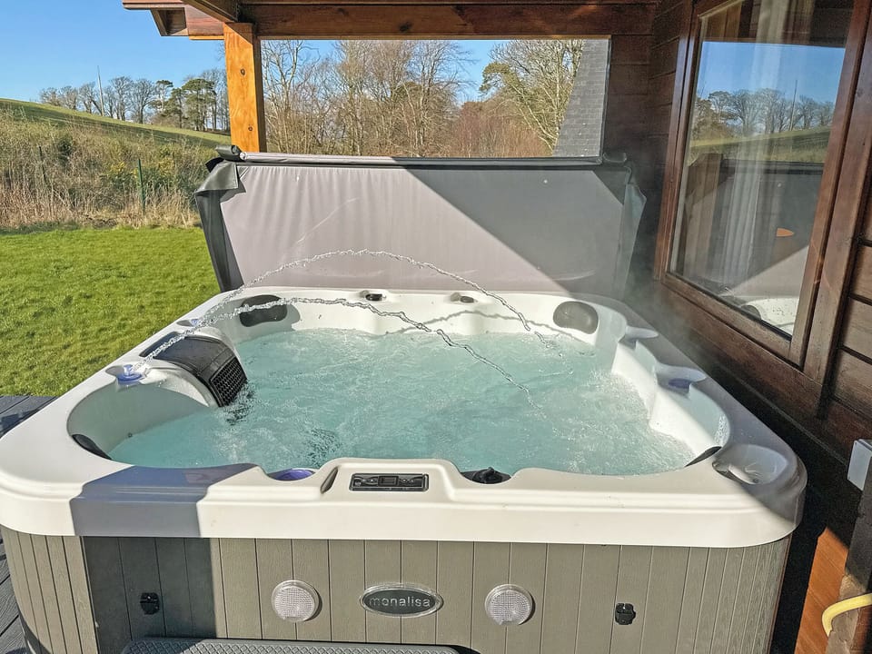 Hot tub on the balcony | Sun Rise Lodge No. 10, Llanbedr