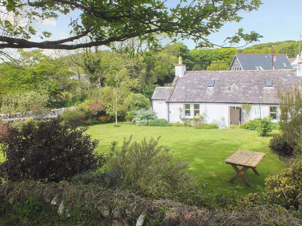 Lovely lawned garden with shady eating area | Gullieside Cottage, Kirkandrews, near Kirkcudbright