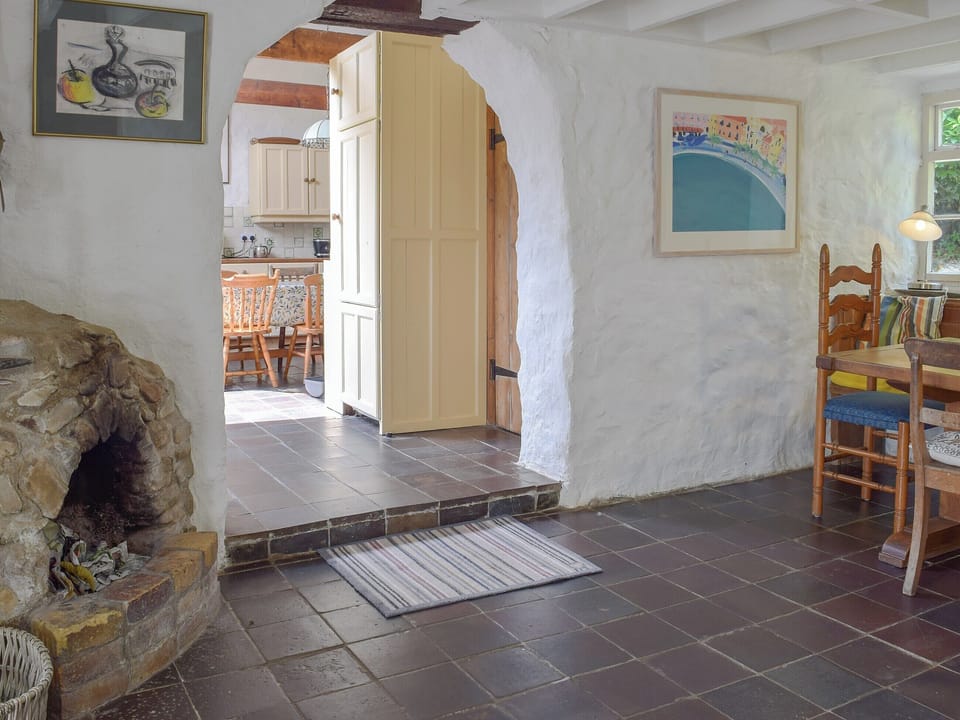 Delightful dining area with a cosy open fire | Lordship FarmhousePottery, Wolfscastle, near Haverfordwest