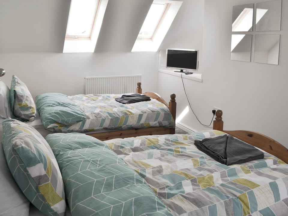 Tastefully decorated bedroom with twin beds | Teal House, Amble