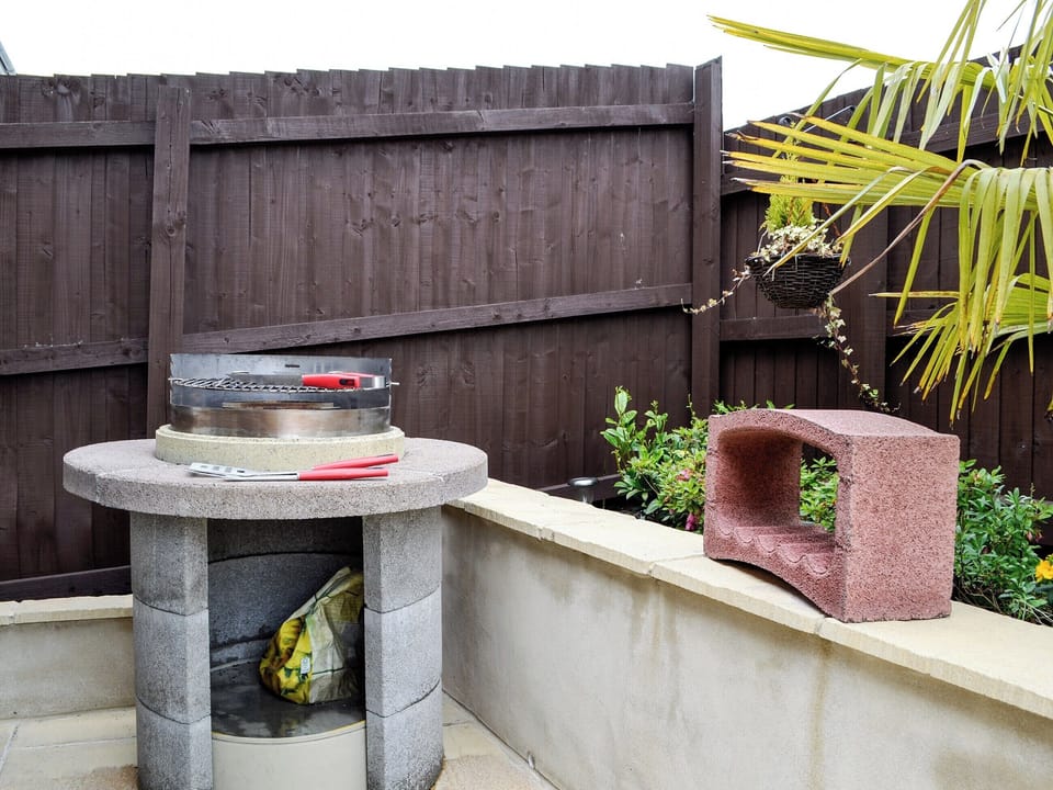 Outdoor dining area with BBQ | Ty Cerrig, Cwmgors, near Ammanford