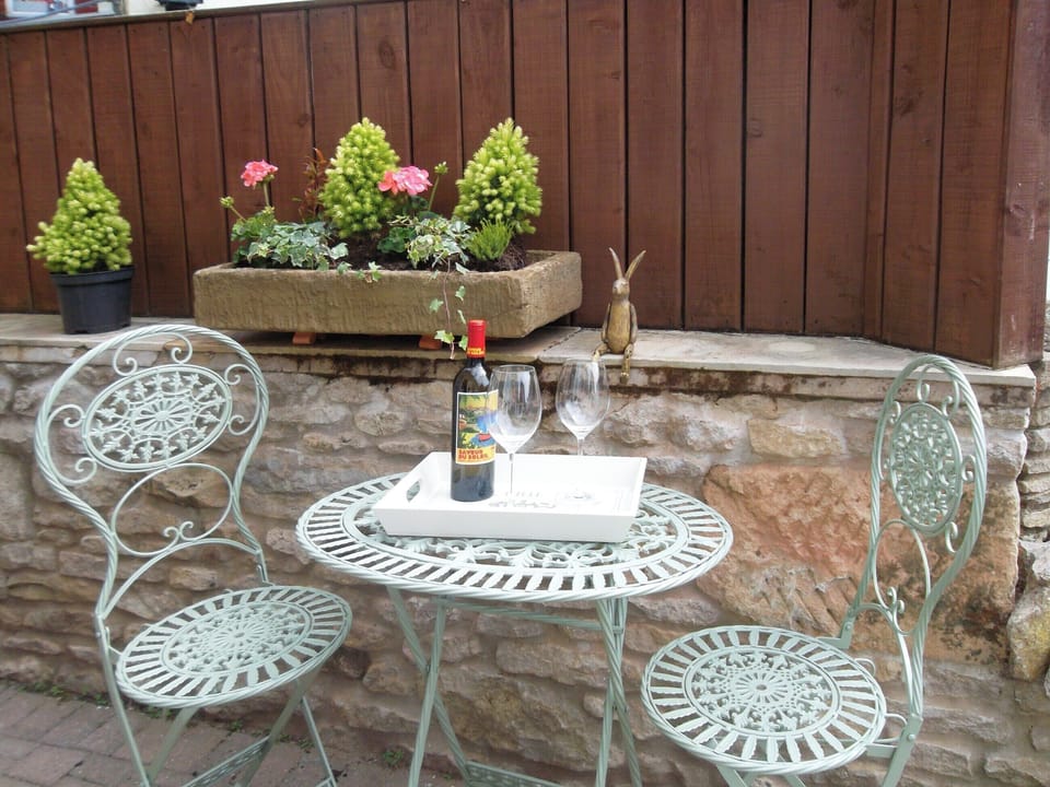 Paved patio area with outdoor furniture | West Wood Hideaway, Wrelton, near Pickering 