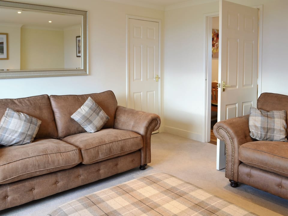 Comfy seating in living room | Foulden Hill Farm Cottage, Foulden